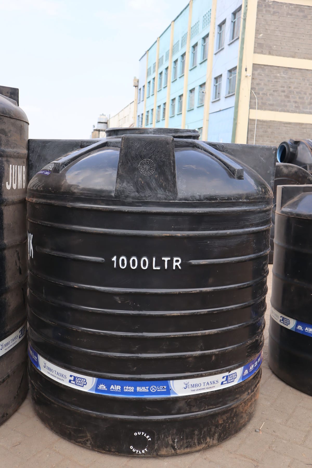 A 1,000 litre Jumbo Tank with the outlet marked at the base and the product band around the body.